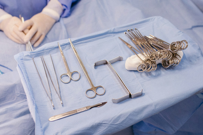 A hospital bed with surgical equipment on top of it